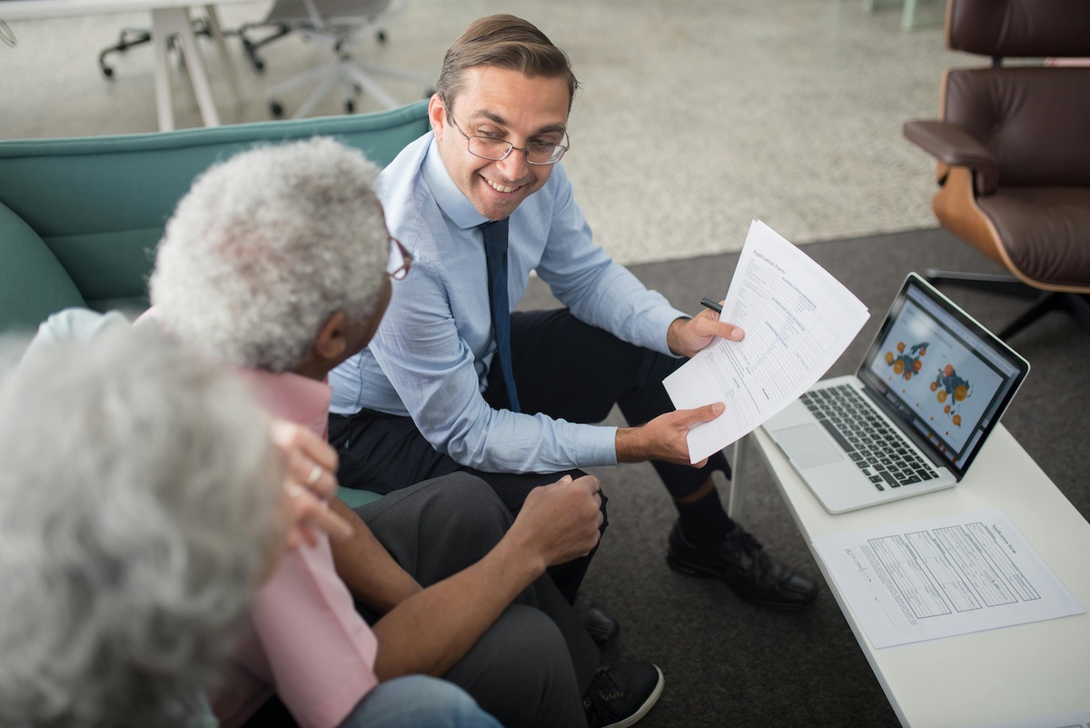 Older couple discussing finances with an advisor.