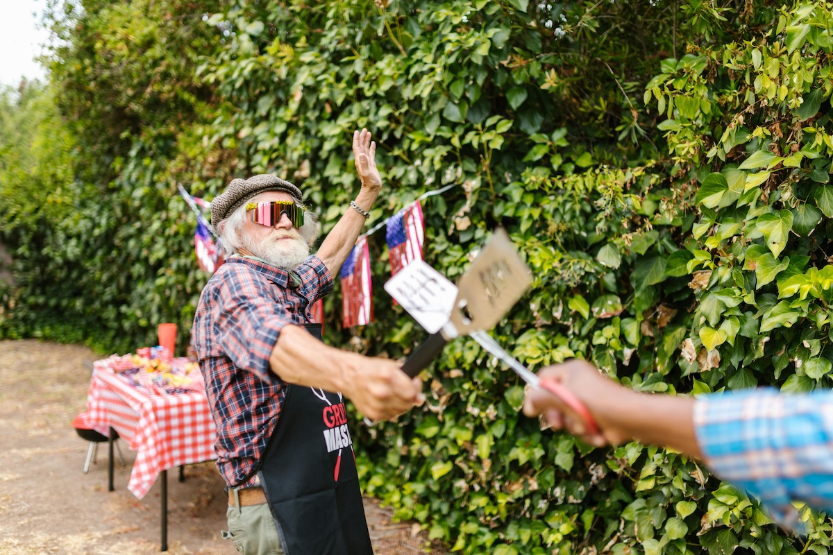 Older man playing prank at a BBQ.