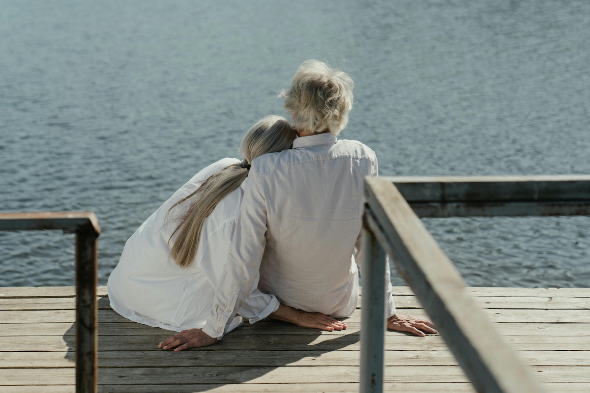 Retired couple sitting on a dock along the St John's River in Palatka, Florida.